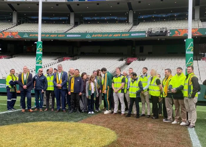 A group picture featuring attendees of the Australian Made Week launch under the MCG footy posts